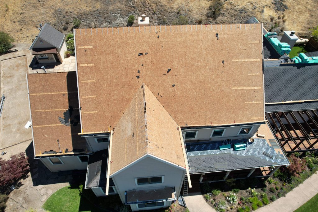 Aerial view of roof with exposed plywood before replacement Los Angeles