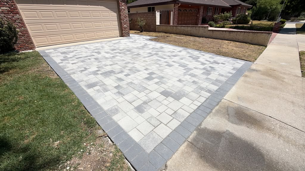 Custom gray paver driveway with contrasting border