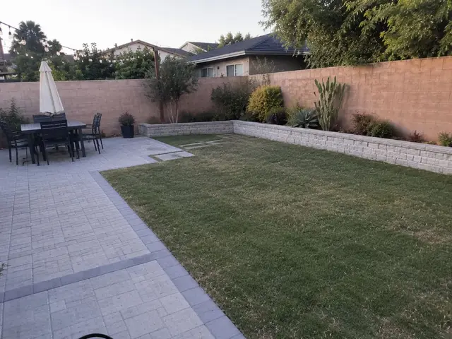 Backyard patio with lawn and retaining wall Los Angeles