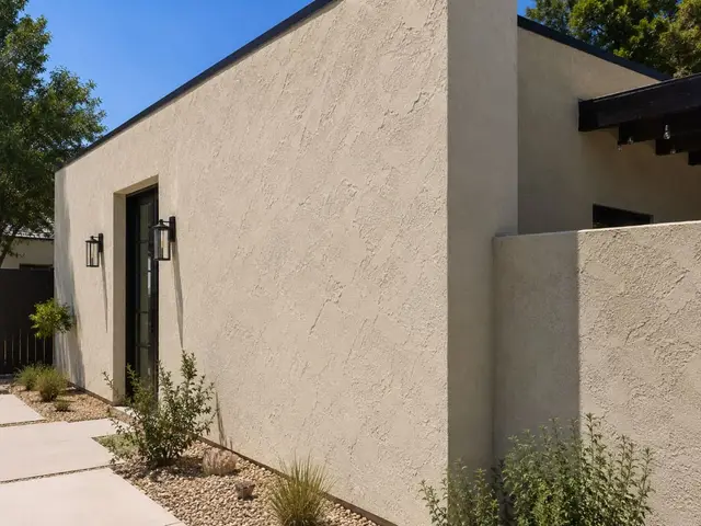 Modern beige stucco home exterior with desert landscaping California