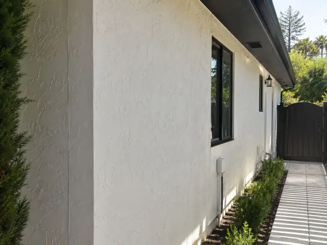 Completed white stucco exterior with black trim and gate Los Angeles