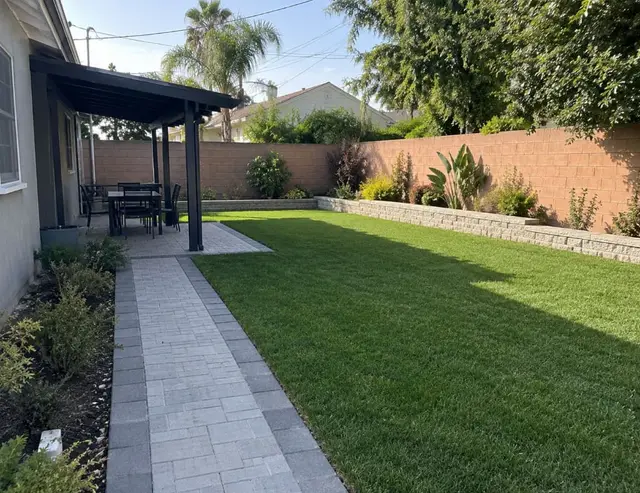Backyard paver path and artificial turf landscaping California